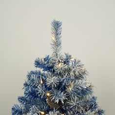 a small blue christmas tree with lights on it