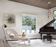 a living room filled with furniture and a grand piano