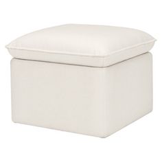 a white ottoman sitting on top of a white floor