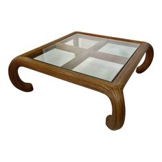 a coffee table with glass top and wooden frame on the bottom, against a white background