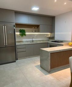 a modern kitchen with stainless steel appliances and marble counter tops is pictured in this image