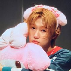 a man holding a pink stuffed animal in his hands