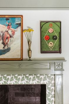 two paintings on the wall above a fireplace