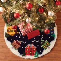 a christmas tree skirt with presents under it