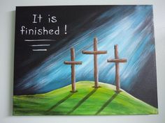 a painting of three crosses on a hill with the words it is finished above them