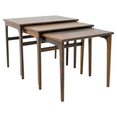 three wooden nesting tables with one sitting on the other