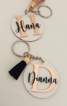 two personalized acrylic key chains with tassels