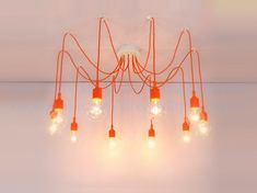 an orange chandelier with five bulbs hanging from it