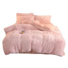 a bed with pink fur and pillows on it