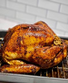 a roasted chicken sitting on top of a grill