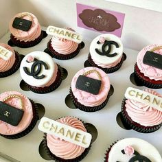 cupcakes with pink frosting and chanel decorations