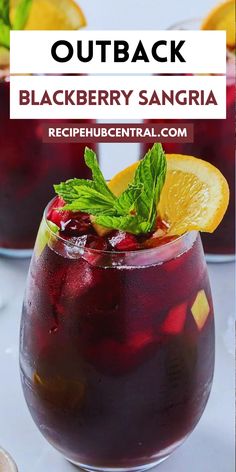 two glasses filled with black berry sangria and garnished with mint