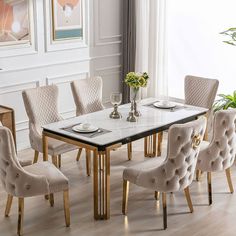 a dining room table set with beige chairs