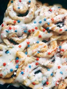 a close up of a doughnut covered in icing and sprinkles