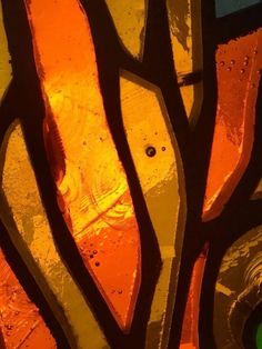 an orange and yellow stained glass piece