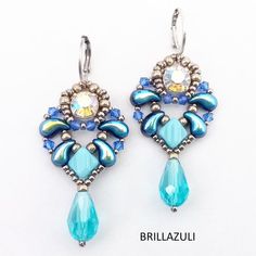 two pairs of earrings with blue beads and crystal stones on the bottom one is dangling from a hook