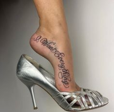 a woman's foot with a tattoo on it