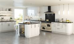 a kitchen with white cabinets and black counter tops, red range hood over the stove