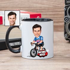 a coffee mug with an image of a man riding a bike on the front and side