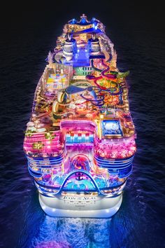 a large ship with many lights on it's side in the middle of the ocean