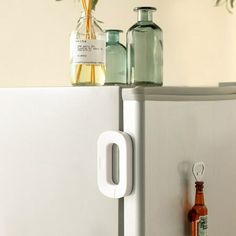 there are two bottles on top of the refrigerator door, one is empty and the other is closed