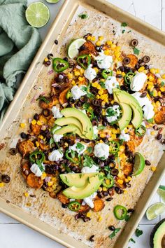 an overhead view of a platter with black beans, corn, avocado and sour cream