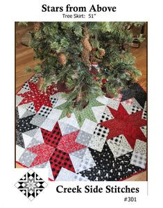 the cover of stars from above, featuring a quilted christmas tree skirt with red and black squares on it