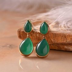 Bringing in the vibrant green to enhance your charm! Set in 16K Gold plated, these beautiful gold plated Cabachon pear-shaped earrings is perfect on any outfit. To work, parties or myself time, it gives you the confidence to face the world. Green Onyx Stone is known for its calming influence. The green soothing stone of Onyx has the power to relieve all your worries, tension, stress, and fear.   16Kt Gold Plated  Gross Wt- 9.55 Gms  Green Onyx Cabachon Pear Shaped - 8X13 Mm - 2 Pcs Green Onyx Ca Classic Green Drop Jewelry, Green Teardrop Gemstone Earrings, Green Onyx Drop Earrings For Gifts, Green Cabochon Drop Earrings, Elegant Green Onyx Gold Earrings, Green Gemstone Oval Cabochon Earrings, Green Onyx Stone, Gold Polish, Green Onyx