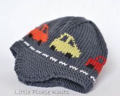 there is a knitted hat with cars on it