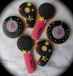 decorated cookies are arranged in the shape of tennis rackets