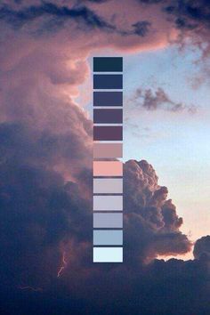 the sky is filled with clouds and there are two different colors on each side of the tower