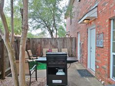 an outdoor bbq grill sitting next to a patio