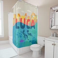 a bathroom with a shower curtain that has an image of a city on the side