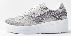 The WX-100 is a classic tennis style with a modern chunky sole, featured in snake print leather with embroidered FILA logos on the tongue, quarter and back counter. Content + Care - Leather, rubber - Spot clean - Imported Size + Fit - True to size - Heel height: 1.75” - Platform height: 1.25” Luxury Chunky Sneakers With Textured White Sole, Luxury Suede Platform Sneakers With Textured Sole, Luxury Canvas Platform Sneakers With Round Toe, Luxury Chunky Sneakers For Women With Round Toe, Luxury Platform Sneakers With Embossed Logo And Round Toe, Luxury Low-top Platform Sneakers With Leather Sole, Luxury White Platform Sneakers With Contrasting Heel, Luxury Sporty Platform Sneakers With Leather Sole, Luxury Suede Platform Sneakers With Contrast Sole