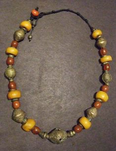 Necklace of African brass bicones and donuts with copal beads, 25 inches, If you like this, you may be interested in jewelry on my other etsy site. Here are a few links: https://www.etsy.com/listing/203896817/ethnic-multi-strand-necklace-in-copal?ref=featured_listings_row https://www.etsy.com/listing/184337879/multi-strand-treasure-necklace-combining?ref=featured_listings_row https://www.etsy.com/listing/275355612/pendant-style-necklace-made-with-polymer?ref=shop_home_listings https://www.etsy.c White Bohemian, Pony Beads, Multi Strand Necklace, Brass Chain, Star Necklace, Multi Strand, Spacer Beads, Green Glass, Vintage Brass