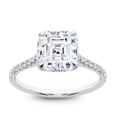 an emerald cut diamond ring with pave set shoulders