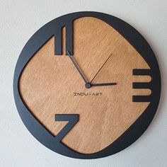 a wooden clock with an image of a fork and knife on the face that says indu art