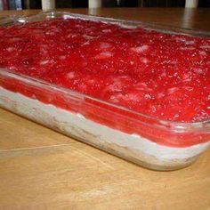 a casserole dish filled with strawberries on top of a wooden table