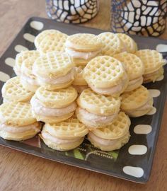 some waffles are on a black plate with white polka dots