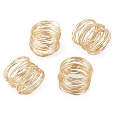 four gold - plated wire rings on a white background with clipping for text