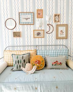 a bed with pillows and pictures on the wall