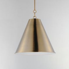 a large brass pendant light hanging from a ceiling