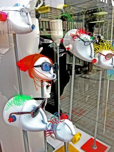 a window display with various items in the shape of cats and mice, including eyeglasses