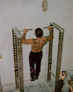 a man standing on top of a metal lift