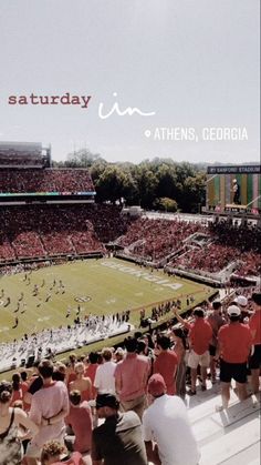 a stadium filled with lots of people standing on top of a field