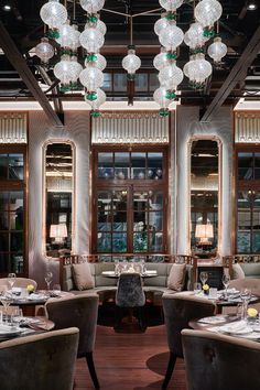 a restaurant with tables, chairs and chandeliers