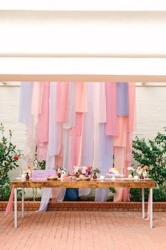 a long table with cake and cupcakes on it