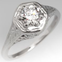 This beautiful vintage filigree engagement ring features a .62 carat transitional cut center diamond grading E in color and VS1 in clarity, GIA certified. The ring is crafted of platinum and shows light overall wear but is still in beautiful condition. The ring is currently a size 6 and we offer complimentary resizing to fit. Classic White Filigree Ring With Brilliant Cut, Classic Diamond Cut Filigree Ring, Diamond White Classic Filigree Ring For Anniversary, Classic Diamond White Filigree Ring For Anniversary, Diamond White Filigree Wedding Dress, Exquisite Filigree Ring With Brilliant Cut For Anniversary, Classic Filigree Ring With Brilliant Cut For Wedding, Formal Diamond Solitaire Filigree Ring, Formal Solitaire Filigree Ring Fine Jewelry