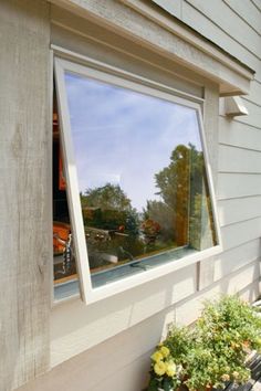 a house with a large window reflecting the street