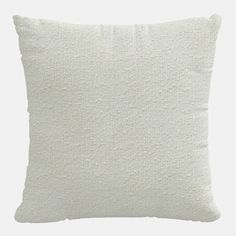 a white pillow that is made out of fabric and has small holes on the front